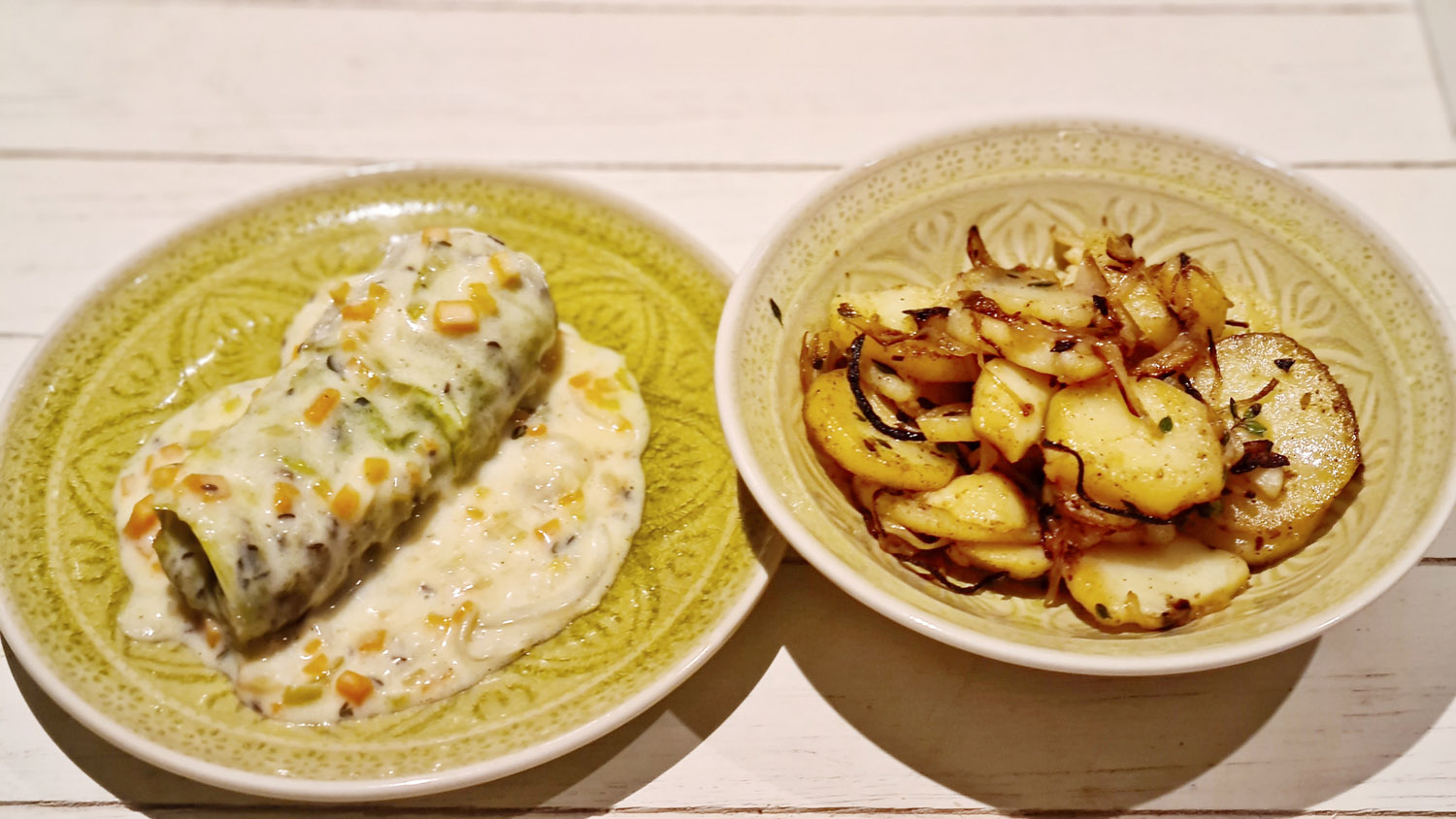 French stuffed cabbage roll served with creamy sauce and Lyonnaise potatoes