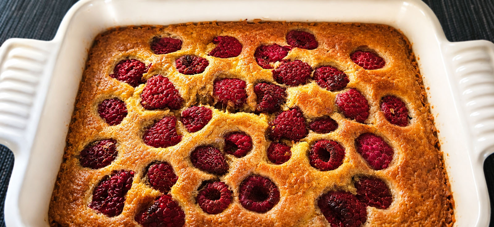 Freshly baked Rustic Apple & Raspberry Oat Bake with raspberries