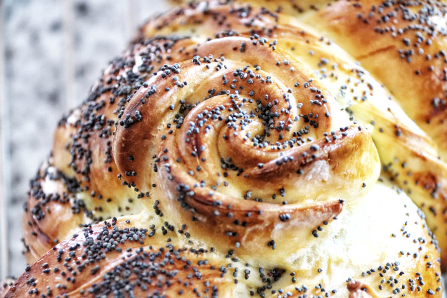 Close-up of Swiss butter plait topped with poppy seeds