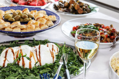 Italian catering buffet and a glas of white wine by Angela Carnelutti in Zurich with Mediterranean and Neapolitan dishes