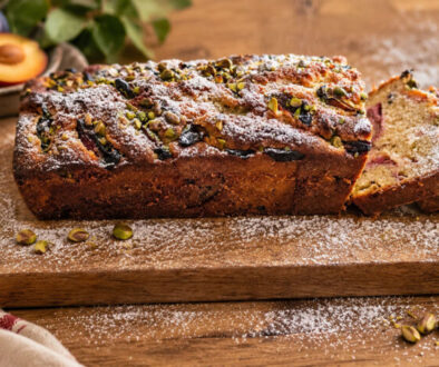 Autumn Plum & Pistachio Cake with fresh plums, chopped pistachios and powdered sugar