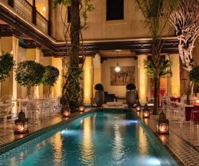 Pepe Nero Marrakech courtyard and pool illuminated at night