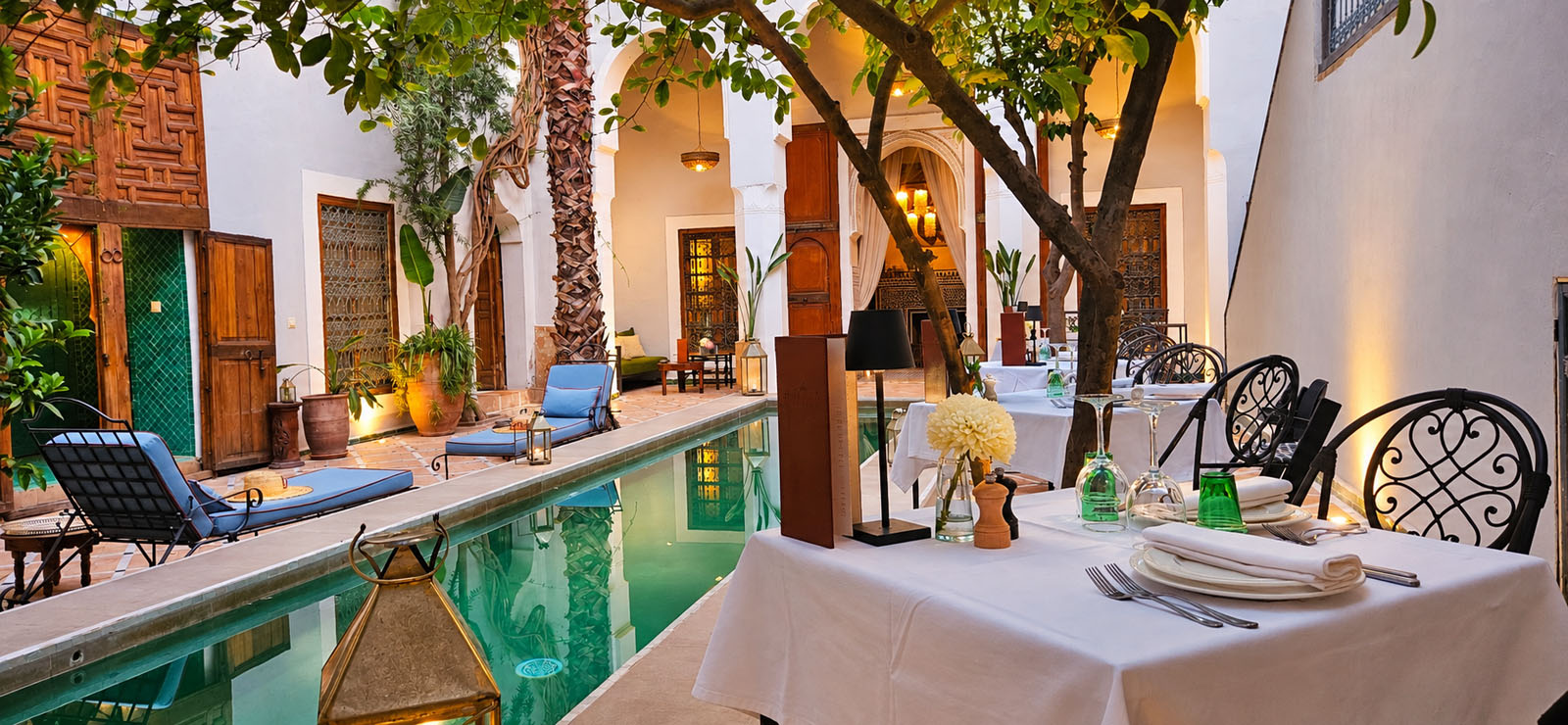 Dinner table beside the courtyard pool at Riad Le Rihani Marrakech