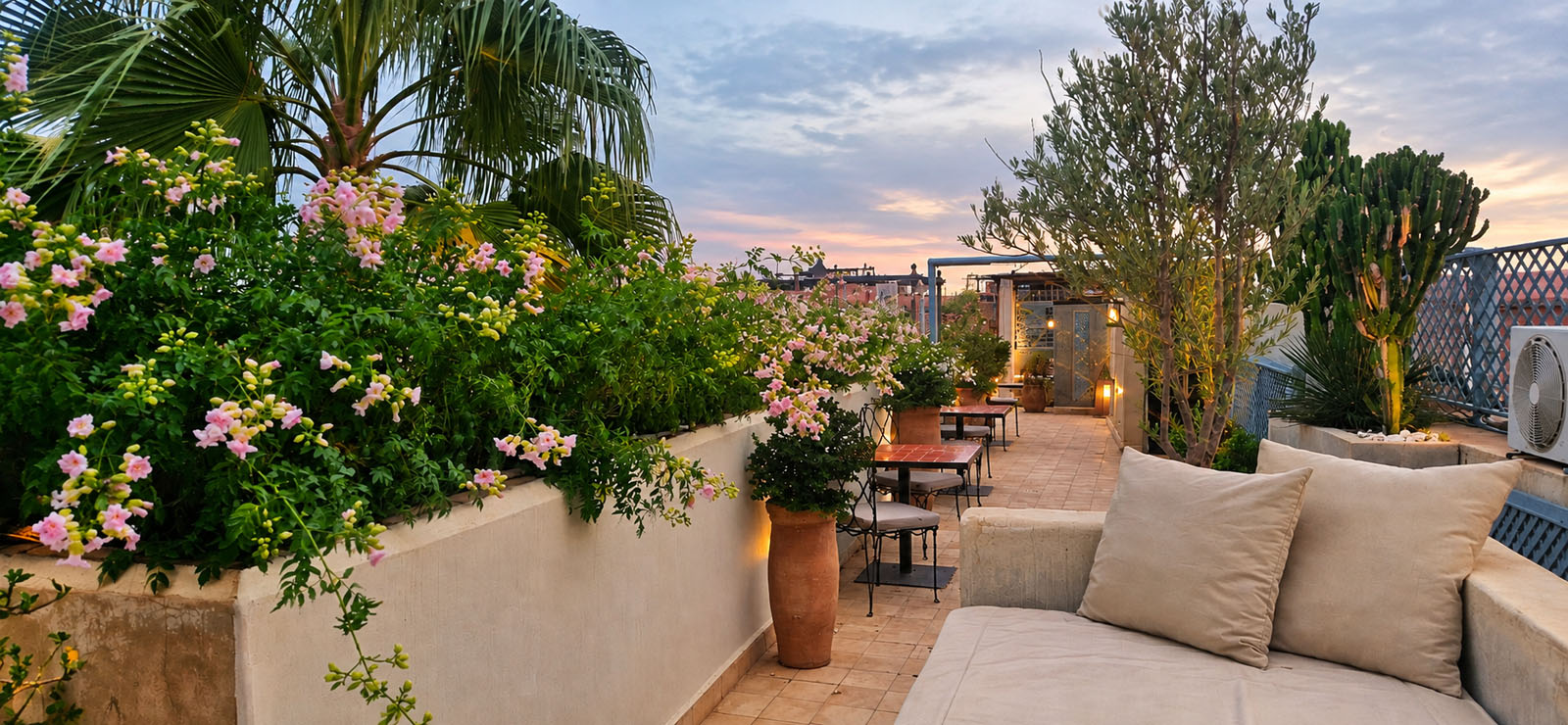 Rooftop garden at Riad Le Rihani Marrakech with flowering plants and seating
